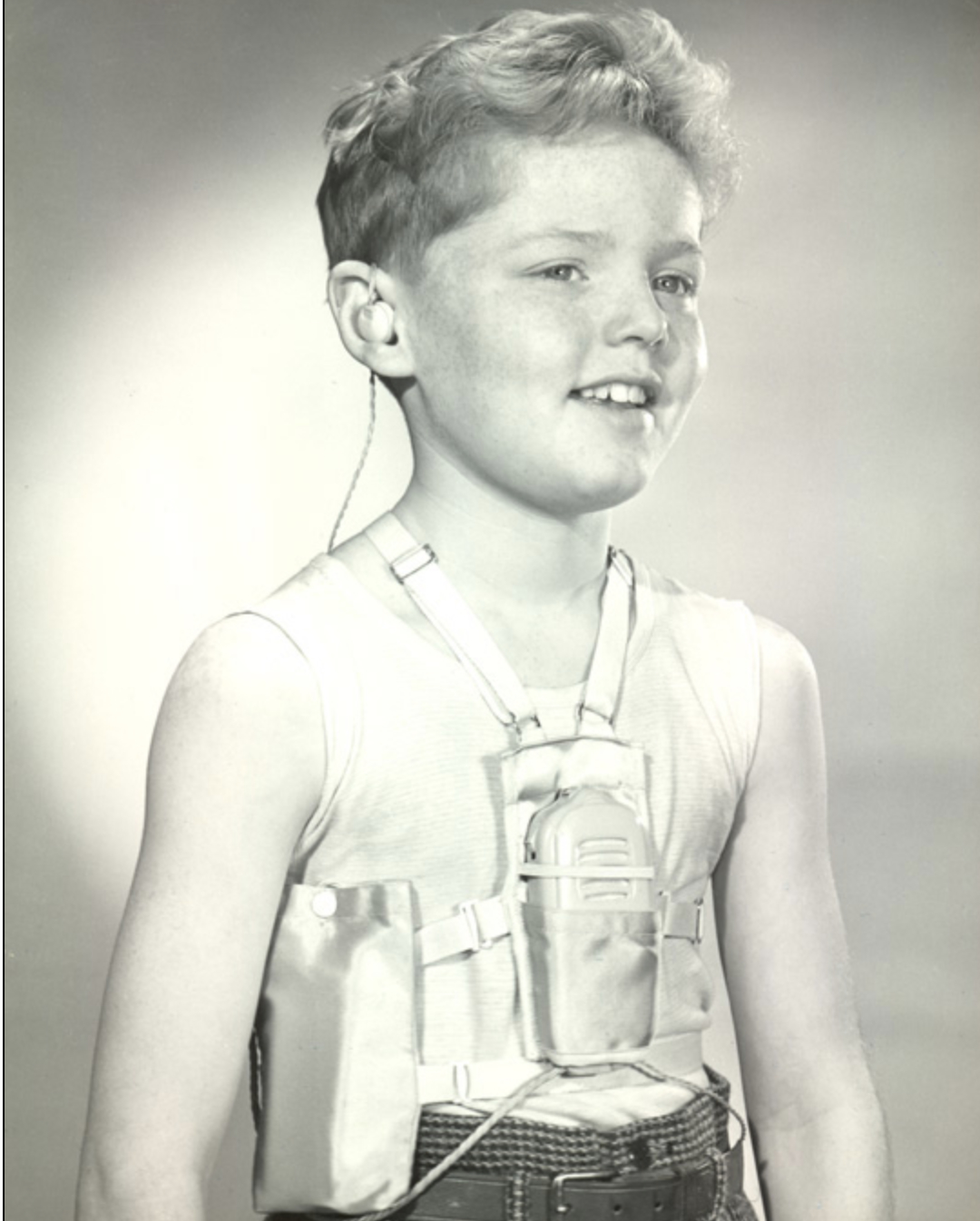 Body worn NHS hearing aid for children, batteries under arm